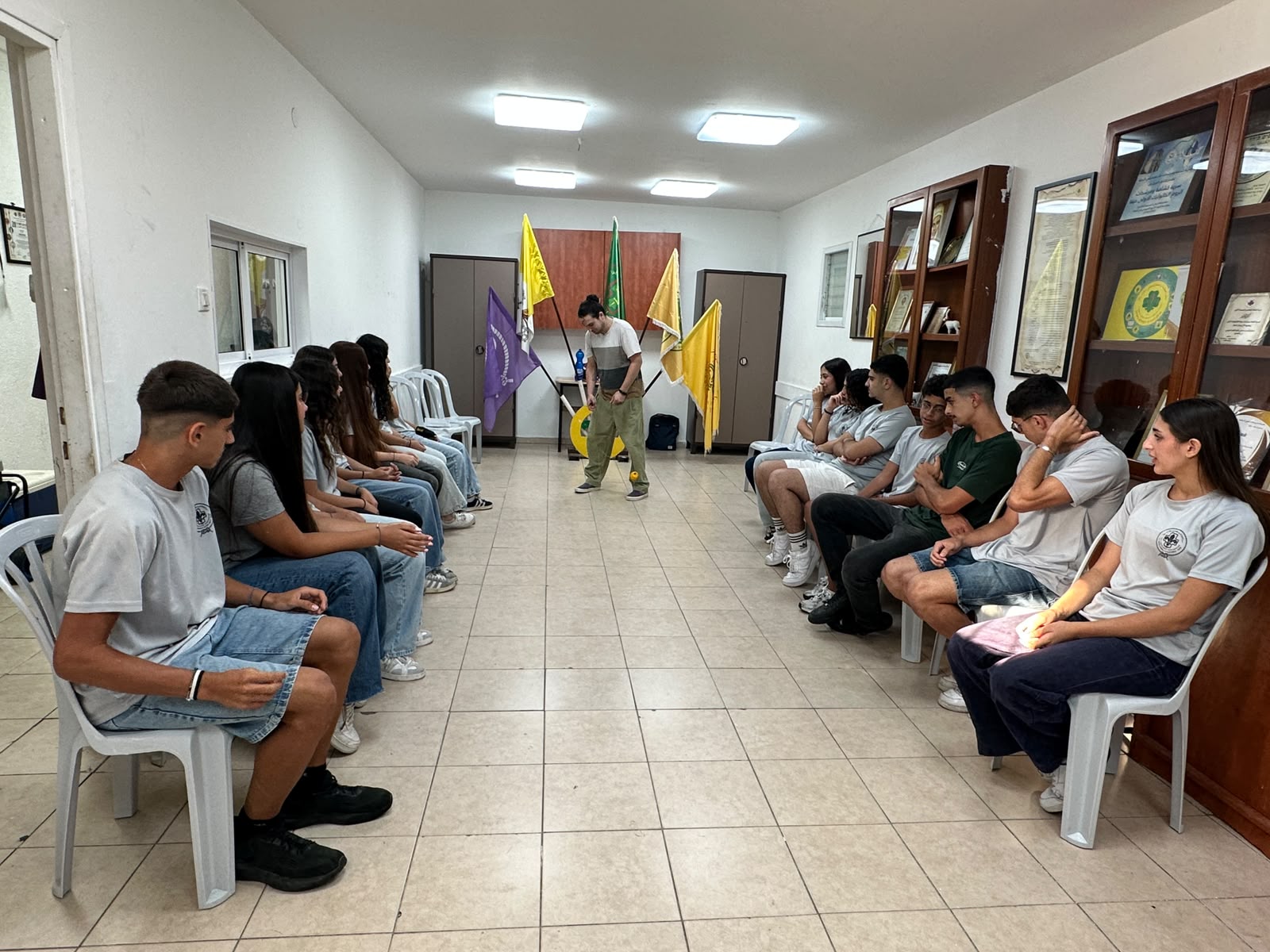 A session under way in the scouts' den, participants seated in a circle on the floor.